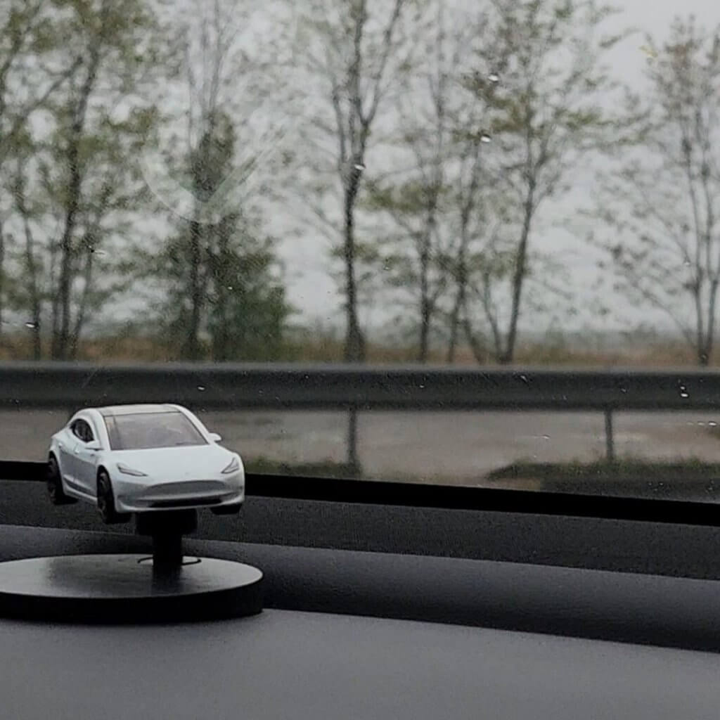 Rotating Tesla Model 3 miniature model on a dash